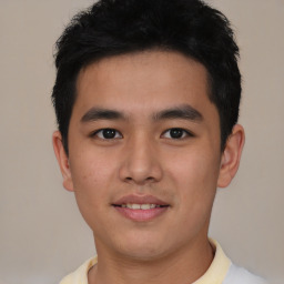 Joyful asian young-adult male with short  brown hair and brown eyes