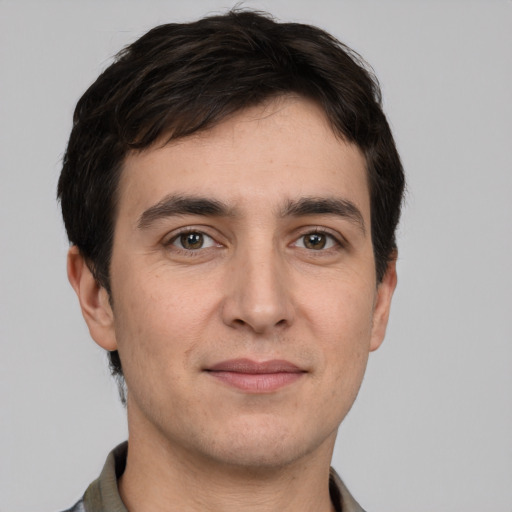 Joyful white young-adult male with short  black hair and grey eyes