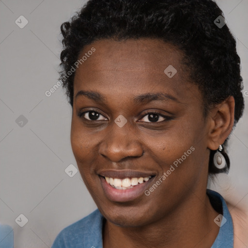 Joyful black young-adult female with short  brown hair and brown eyes