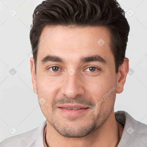 Joyful white young-adult male with short  brown hair and brown eyes