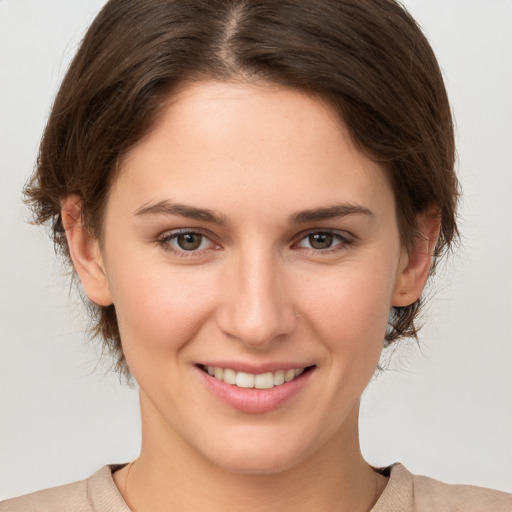 Joyful white young-adult female with medium  brown hair and brown eyes