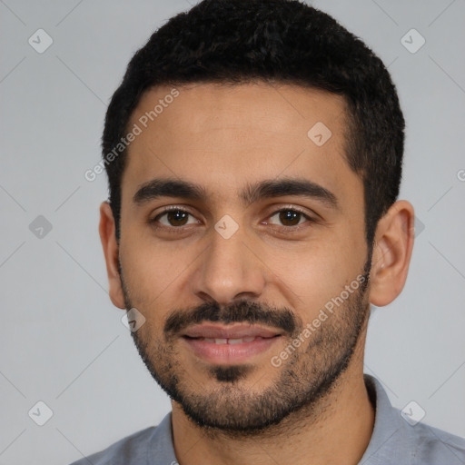 Joyful latino young-adult male with short  black hair and brown eyes