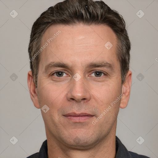 Joyful white adult male with short  brown hair and grey eyes