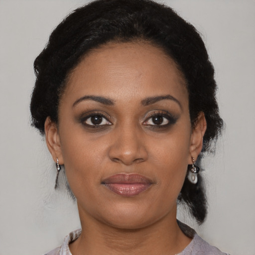 Joyful black young-adult female with medium  black hair and brown eyes