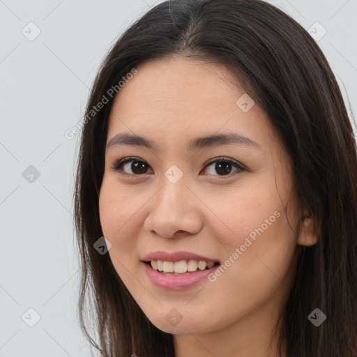 Joyful asian young-adult female with long  brown hair and brown eyes