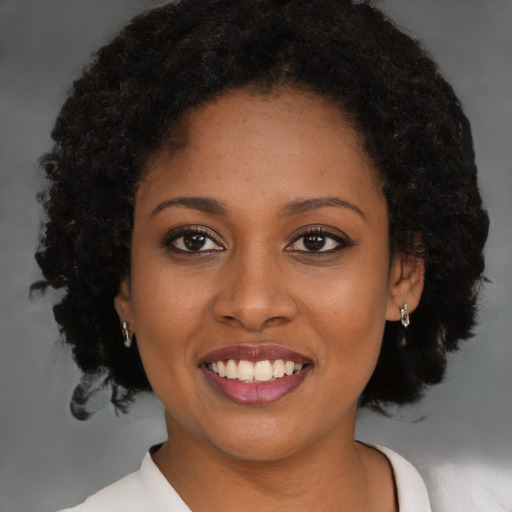 Joyful black young-adult female with medium  brown hair and brown eyes