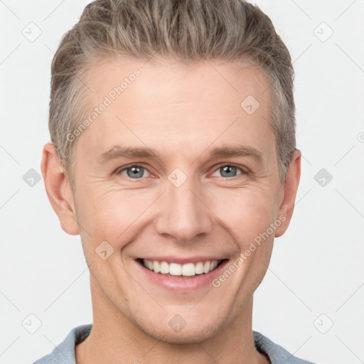 Joyful white adult male with short  brown hair and grey eyes