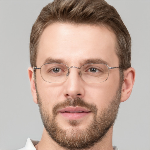 Joyful white adult male with short  brown hair and brown eyes