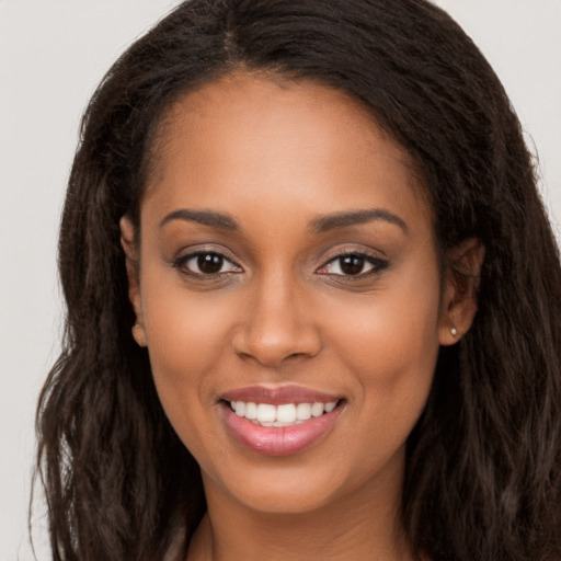 Joyful latino young-adult female with long  brown hair and brown eyes