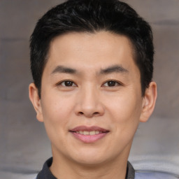 Joyful asian young-adult male with short  brown hair and brown eyes