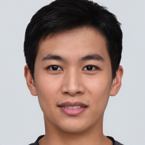 Joyful asian young-adult male with short  black hair and brown eyes