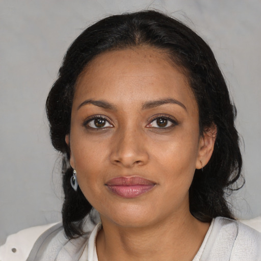 Joyful black young-adult female with medium  black hair and brown eyes