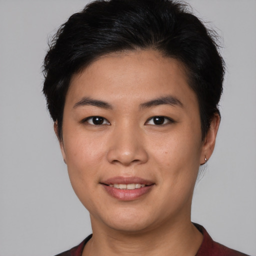 Joyful asian young-adult female with short  black hair and brown eyes