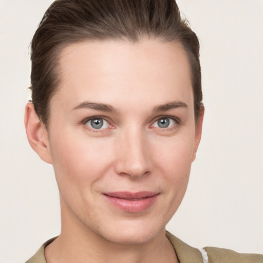 Joyful white young-adult female with short  brown hair and grey eyes