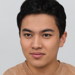 Joyful asian young-adult male with short  black hair and brown eyes