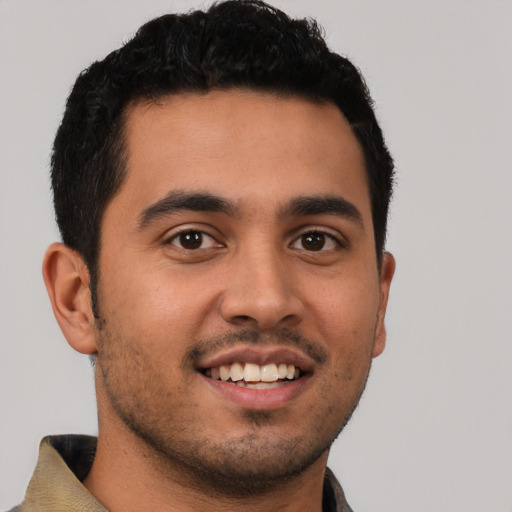 Joyful latino young-adult male with short  brown hair and brown eyes