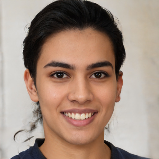 Joyful latino young-adult female with medium  brown hair and brown eyes
