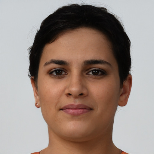 Joyful latino young-adult female with short  brown hair and brown eyes