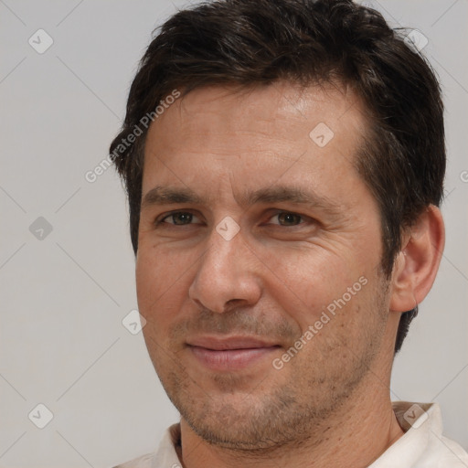 Joyful white adult male with short  brown hair and brown eyes