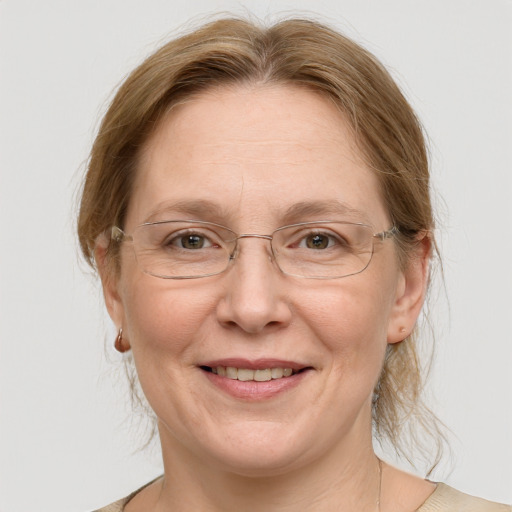 Joyful white middle-aged female with medium  brown hair and grey eyes