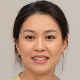 Joyful asian young-adult female with medium  brown hair and brown eyes