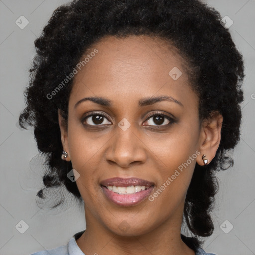 Joyful black young-adult female with long  black hair and brown eyes