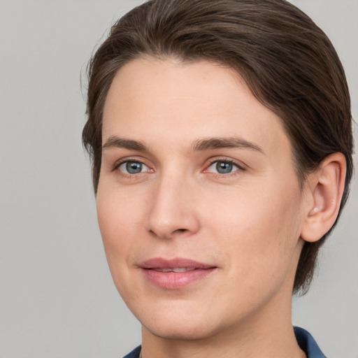 Joyful white young-adult female with short  brown hair and grey eyes