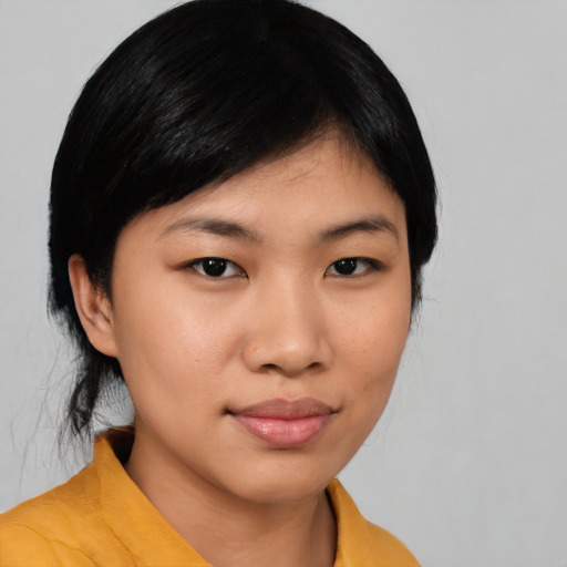 Joyful asian young-adult female with medium  black hair and brown eyes
