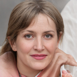 Joyful white young-adult female with medium  brown hair and blue eyes