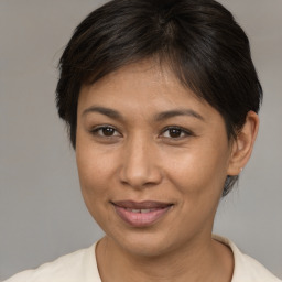 Joyful asian young-adult female with medium  brown hair and brown eyes