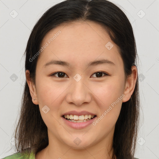 Joyful asian young-adult female with long  brown hair and brown eyes