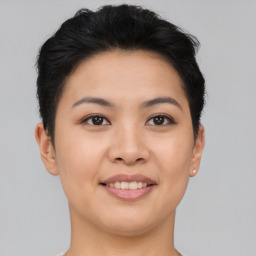 Joyful asian young-adult female with short  black hair and brown eyes