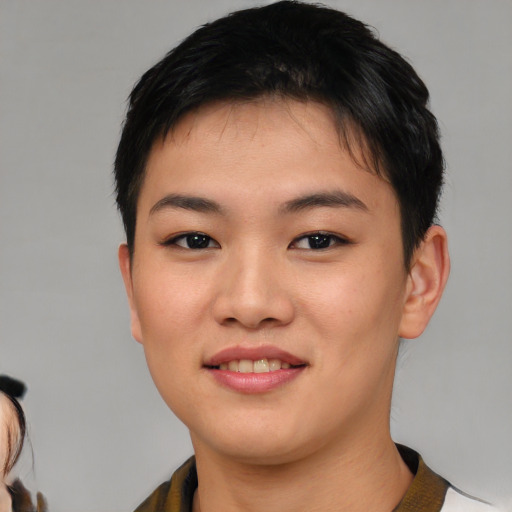 Joyful asian young-adult female with short  brown hair and brown eyes
