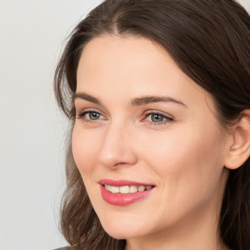 Joyful white young-adult female with medium  brown hair and brown eyes