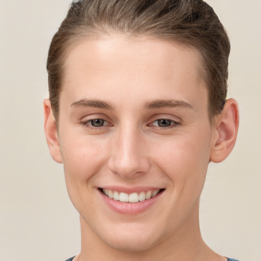 Joyful white young-adult female with short  brown hair and grey eyes