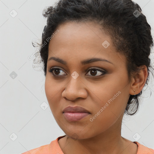 Joyful black young-adult female with long  brown hair and brown eyes