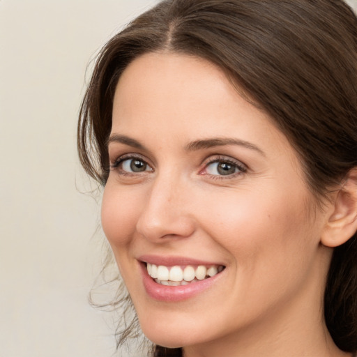 Joyful white young-adult female with medium  brown hair and brown eyes