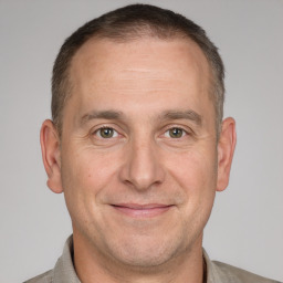 Joyful white adult male with short  brown hair and brown eyes