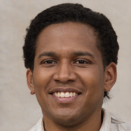 Joyful latino young-adult male with short  brown hair and brown eyes