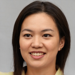 Joyful asian young-adult female with medium  brown hair and brown eyes