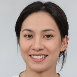 Joyful asian young-adult female with medium  brown hair and brown eyes