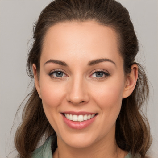 Joyful white young-adult female with long  brown hair and grey eyes