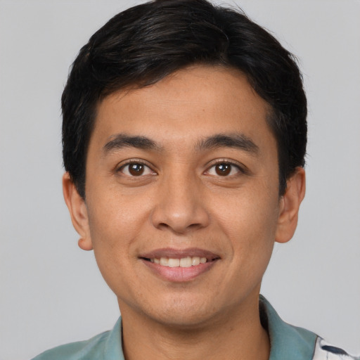 Joyful white young-adult male with short  brown hair and brown eyes