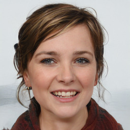 Joyful white young-adult female with medium  brown hair and blue eyes