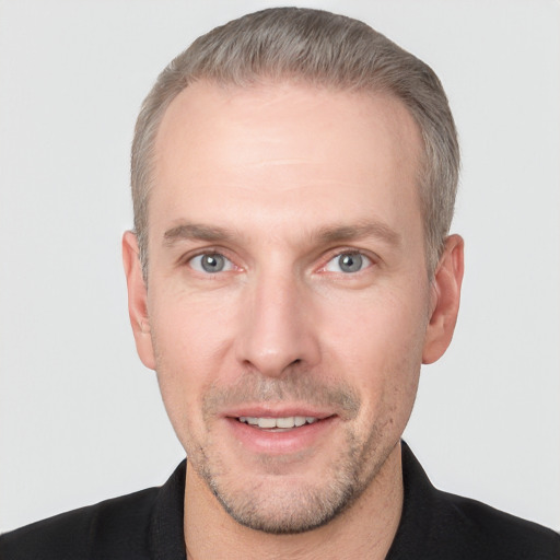 Joyful white adult male with short  brown hair and grey eyes