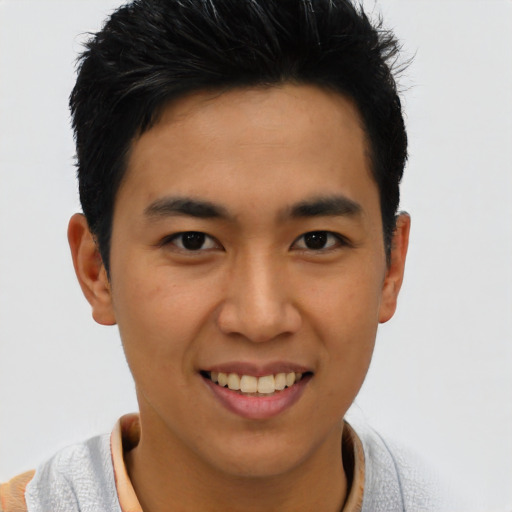 Joyful asian young-adult male with short  black hair and brown eyes