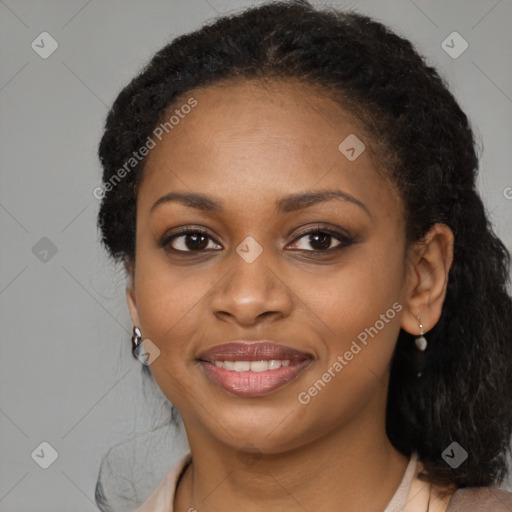 Joyful black young-adult female with long  black hair and brown eyes