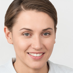 Joyful white young-adult female with short  brown hair and grey eyes