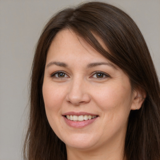 Joyful white young-adult female with long  brown hair and brown eyes