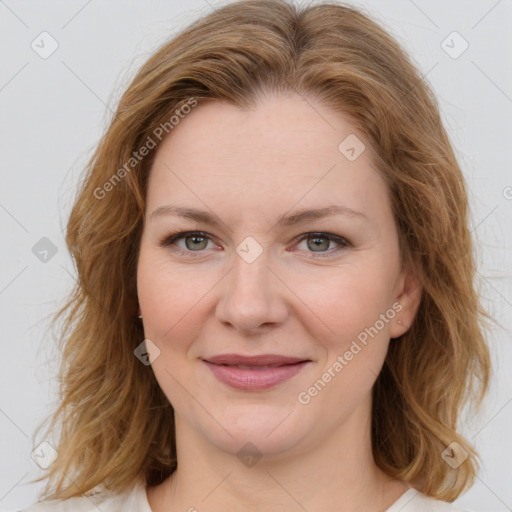 Joyful white young-adult female with medium  brown hair and green eyes